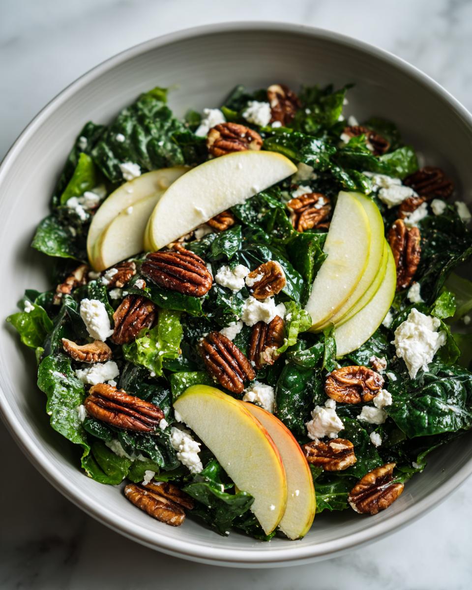 Close-up of a fresh Apple Pecan Salad with crumbled feta cheese and whole pecans.
