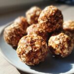 Close-up of a pile of delicious peanut butter energy balls on a plate, made with oats and seeds.