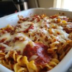 Close-up of a bubbling Pepperoni Pizza Casserole topped with melted mozzarella cheese and pepperoni slices.