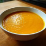 A close-up shot of a bowl filled with creamy Classic Butternut Squash Soup.