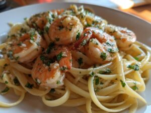 Close-up of succulent shrimp scampi tossed with linguine pasta and fresh parsley.