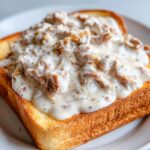A thick slice of golden toast generously topped with creamy chipped beef on toast gravy.