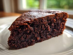Close-up of a perfectly moist chocolate cake slice showing its rich, dark crumb texture.