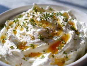 Fluffy white whipped goat cheese topped with golden honey and fresh thyme and rosemary.