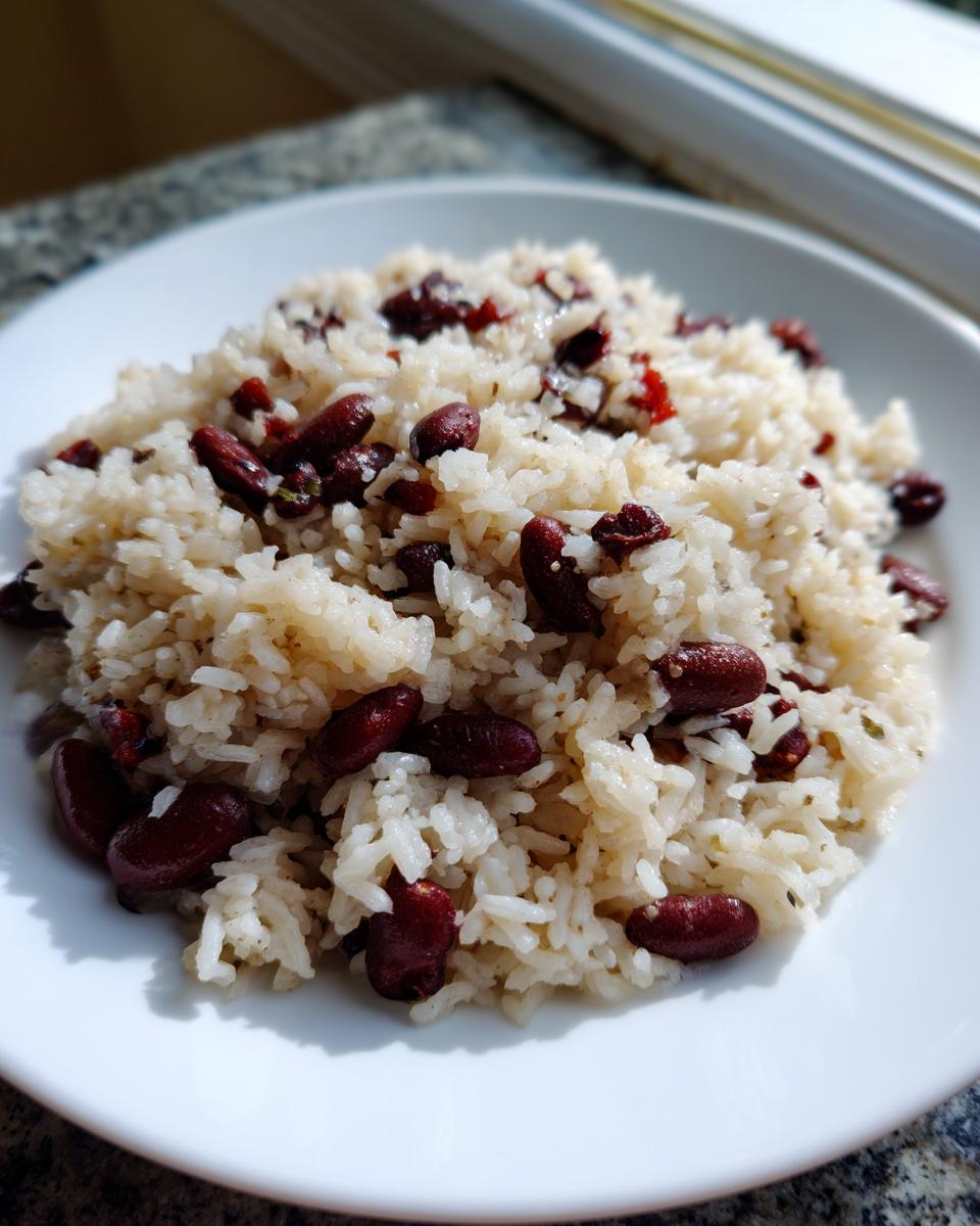 A close-up of white rice mixed with dark red kidney beans, representing the amazing black beans and rice dish.