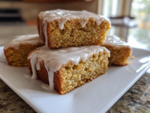 Close-up of stacked soft baked maple donut bars drizzled with white maple glaze.