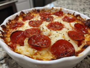 Close-up of a baked cottage cheese pizza bowl topped with melted cheese and crispy pepperoni slices.