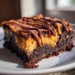 A close-up of a decadent samoa box mix brownies slice with caramel filling and chocolate drizzle.